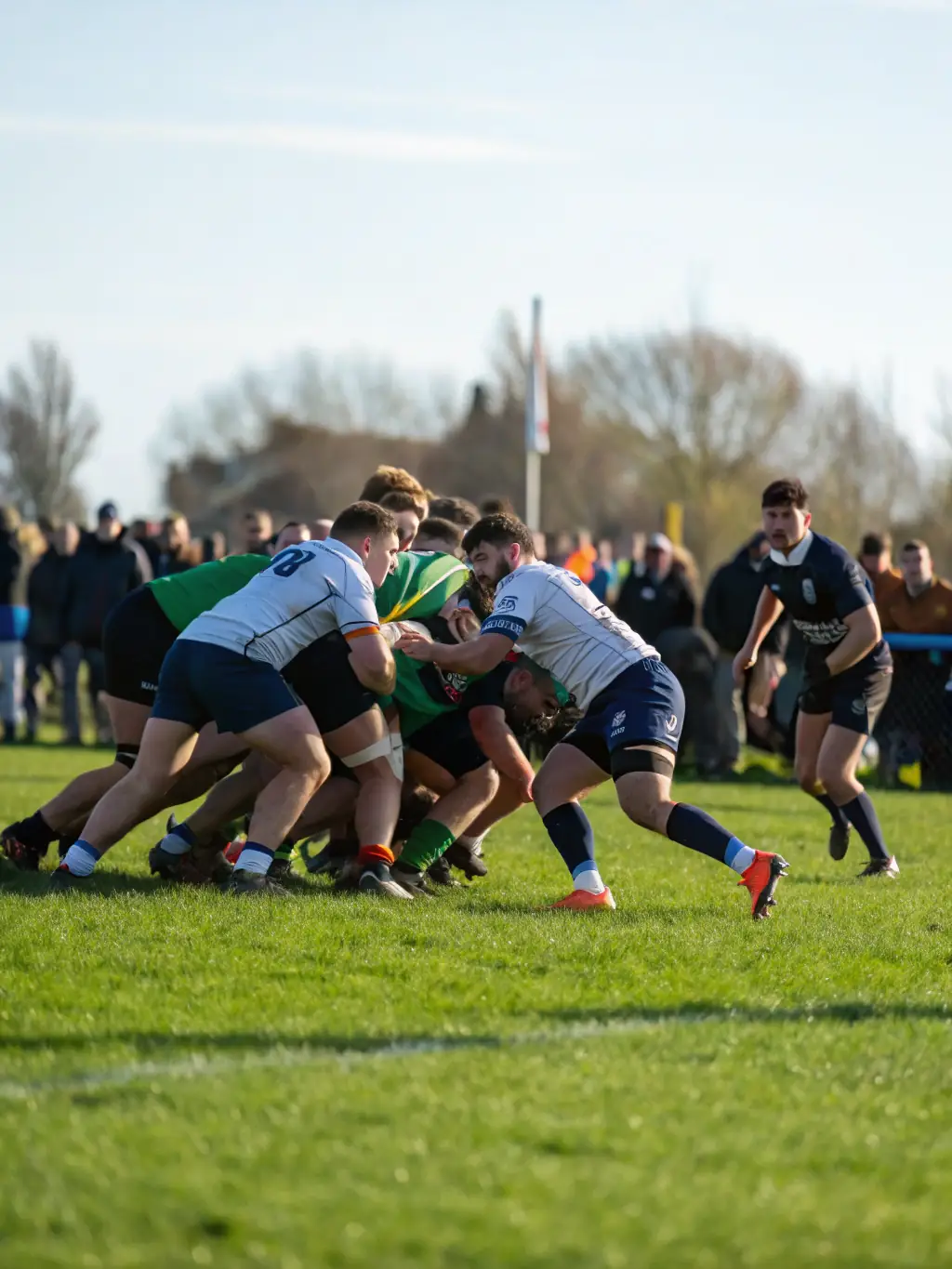A dynamic shot of a rugby match organized by Les Violets de Chanzy, capturing the intensity and excitement of the game. Players are shown in action, with spectators cheering from the sidelines. This image is for the 'Match Day Experiences'.
